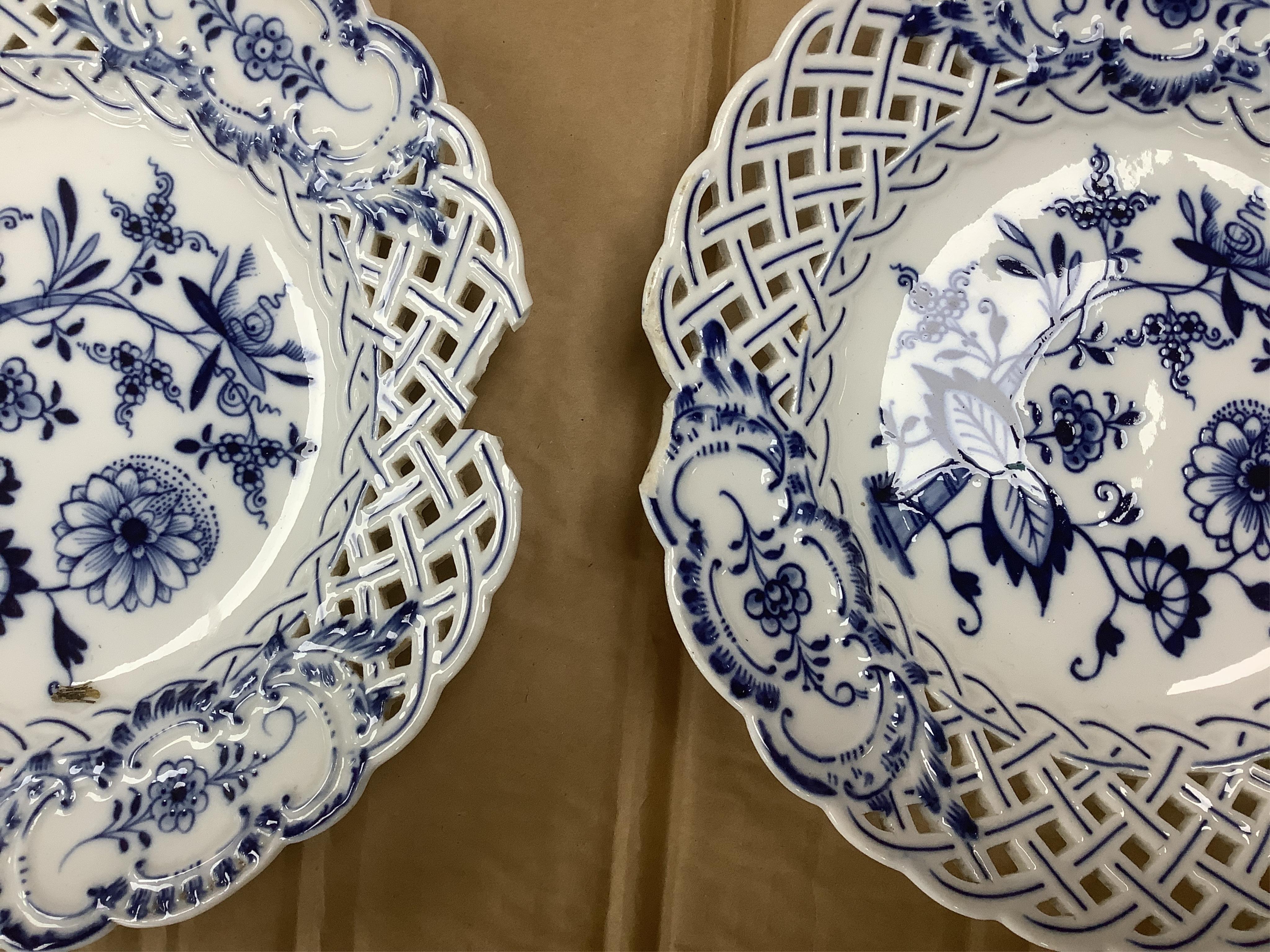 A late 19th Meissen blue and white onion pattern dessert service, consisting of a pair of comports and twelve dishes, all with pierced borders, (14). Condition - poor to good, two plates with pieces of border missing, on